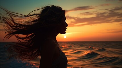 Young woman s silhouette against a sunset over the sea
