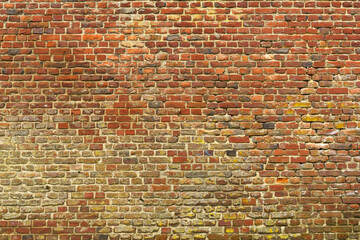 Old red brick wall with different shades. Texture of a brick wall