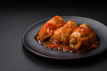 Delicious dolma in tomato sauce with carrots, onions, salt, spices and herbs