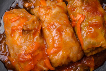 Delicious dolma in tomato sauce with carrots, onions, salt, spices and herbs