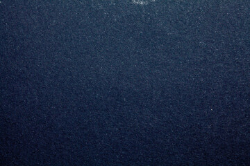 Dark blue textured wallpaper. Grunge image. Film grain