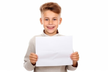 Fototapeta premium Smiling boy kid holding empty paper placard with space for text.