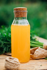 Fresh carrots on a wooden background. Food for vegetarians. Homemade vegetables, eco-friendly, healthy food. Glass jug with carrot juice on a wooden table.