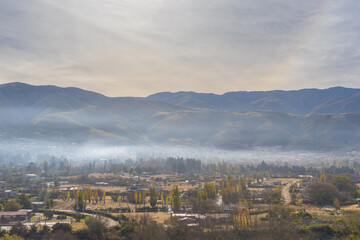 VIEW OF THE CITY OF TAFI DEL VALLE AT DAWN WITH FOG. CALCHAQUIES VALLEYS, TUCUMAN. ARGENTINA.