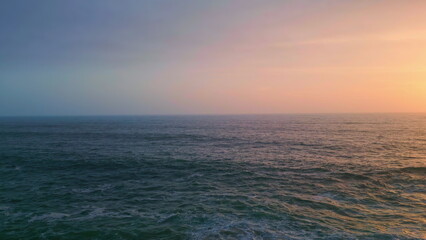 Fototapeta premium Beautiful calm seascape twilight aerial view. Ocean waving under evening sky