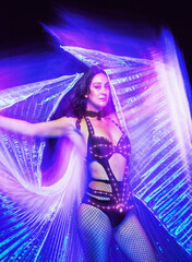 Conceptual artistic portrait of Caucasian woman dancer light costume performer and wings in long...