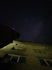 A house against the background of a dark night starry sky