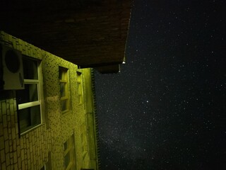 A house against the background of a dark night starry sky