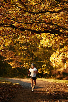 Female Runner in park during golden hour