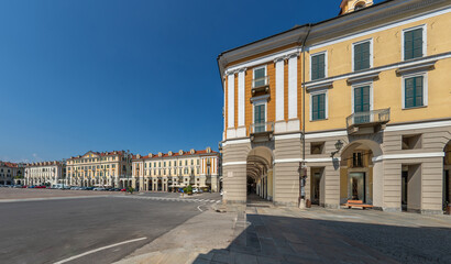 Fototapeta na wymiar Cuneo, Piedmont, Italy - August 16, 2023: Piazza Tancredi Duccio GalimbertI, main square of Cuneo with historic neoclassical buildings, as seen from Via Roma