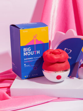 Perm, Russia - July 25 2023: Female vibrator Big Mouth Sustained pleasure. Box and vibrator on pink background