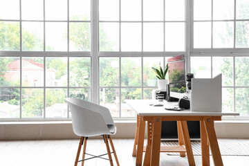 Programmer's workplace in interior of light office