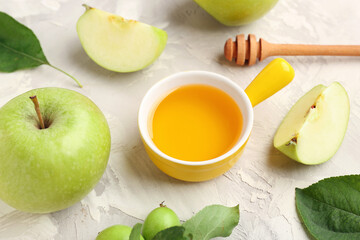 Bowl of honey and apples for Rosh Hashanah celebration (Jewish New Year) on grunge background