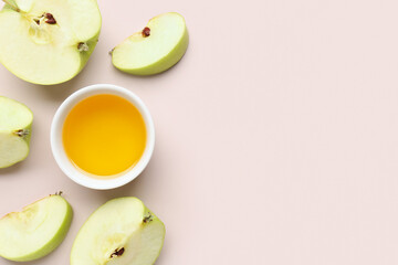 Bowl of honey and apple for Rosh Hashanah celebration (Jewish New Year) on pink background