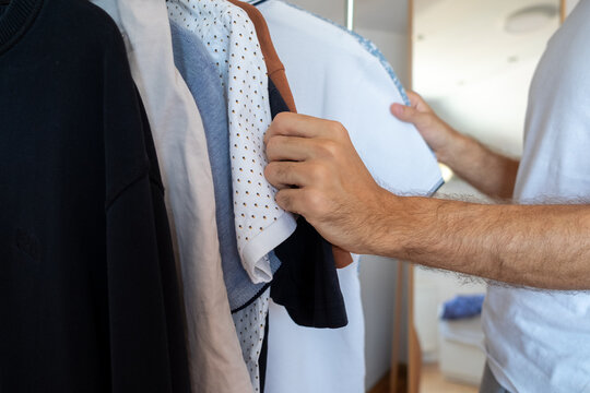 Close-up of an anonymous male choosing what to wear 