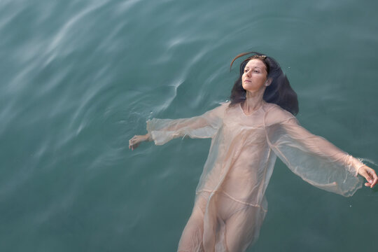 woman floating in water, mental health, apathy and sadness