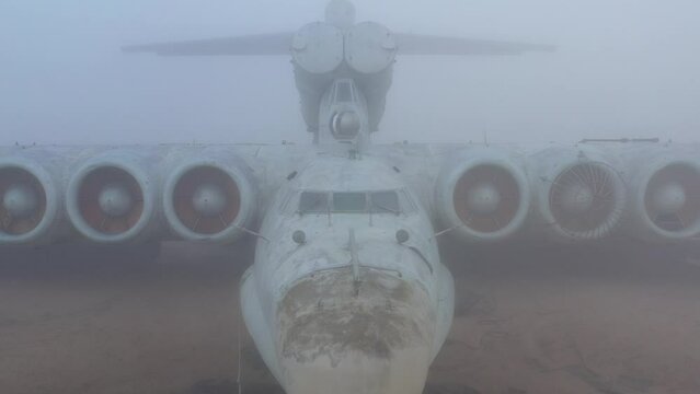 Soviet strike ekranoplan on the shores of the foggy Caspian Sea. Dagestan, Russia.