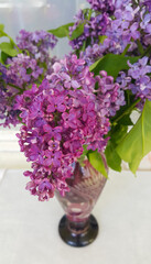 Bouquet of beautiful lilac in a glass vase