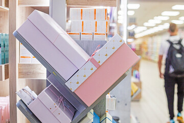 different sizes of gift wrappings on the shelves in the supermarket. Gift for the holiday