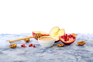 Bowl of sweet honey, fruits and walnuts on color table against white background