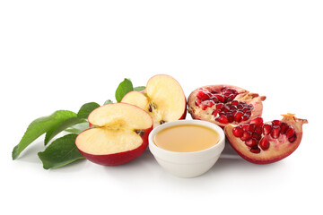 Bowl of sweet honey, ripe apple and pomegranate on white background