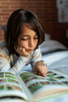 kid reading on bed