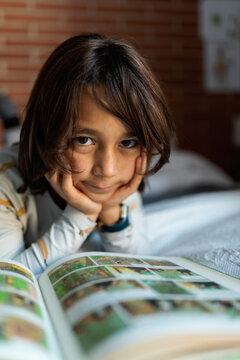 kid reading on bed