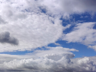 White clouds over blue sky background. Fluffy cumulus cloudscape