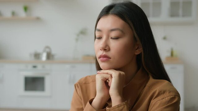 Sad depressed female portrait pensive worried alone Asian girl chinese korean japanese woman suffer loneliness problem hope think deep worry breakup grief melancholy depression sadness at home kitchen