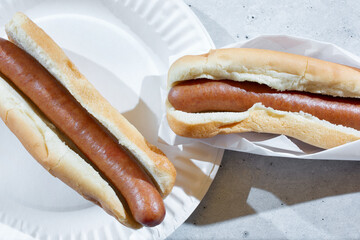 A top down view of two plain hot dogs.
