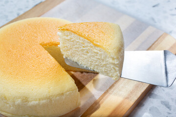 A view of a slice of Japanese cheesecake being served.