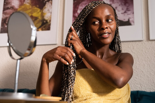 Black woman taking care of Afro braids