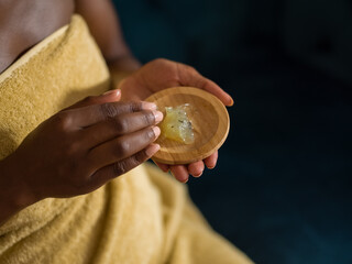 Crop black female taking hair gel