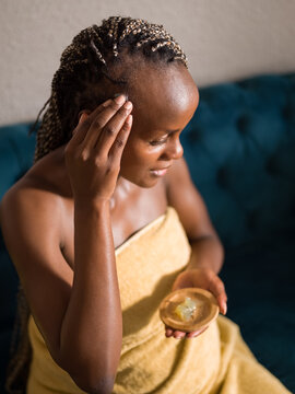 Black woman applying gel on baby hair