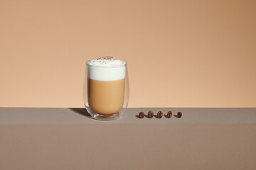 Double wall glass coffee cup isolated on brown