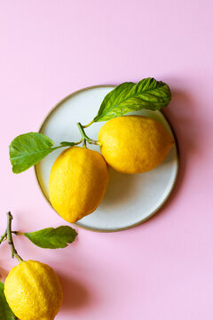 Lemons on bright pink background
