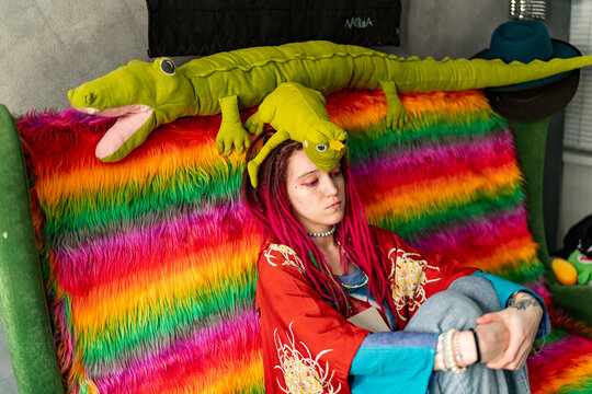 young artist with colored dreadlocks and pink makeup