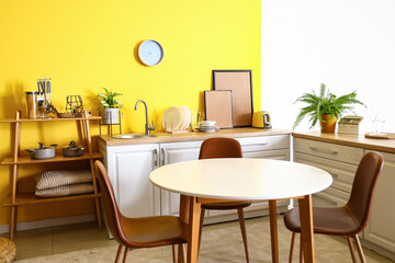 Interior of stylish kitchen with dining table and counters