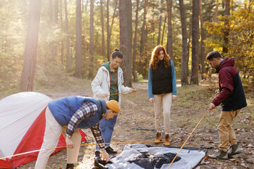 Team set up tent wilderness forest shelter hiking gear