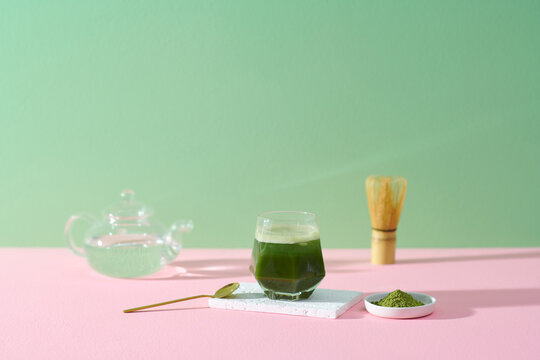 Glass of iced matcha green tea latte with green tea powder