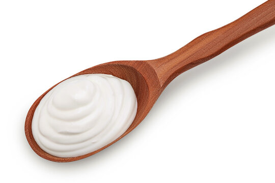 sour cream or yogurt in wooden spoon onion isolated on white background with full depth of field. Top view. Flat lay