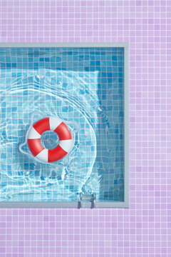 Swimming pool with red and white inflatable ring.