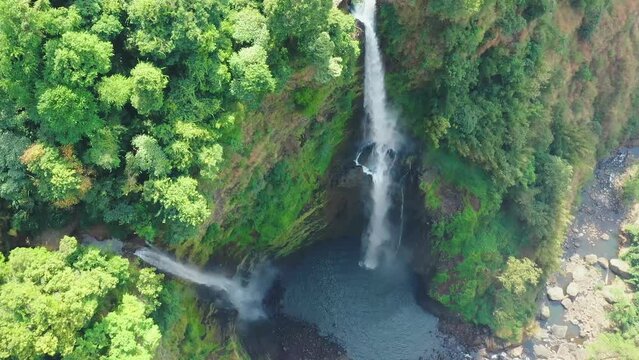 Forward aerial view above Tad Fane waterfall in Bolaven Plateau, Laos. Cinematic drone shot of popular tourist destination along Boloven Loop.