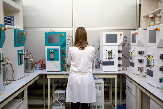 Woman in white lab coat on her back in the laboratory