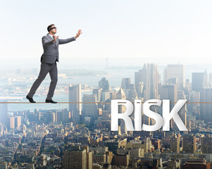 Fototapeta na wymiar Businessman in risk concept walking on tight rope