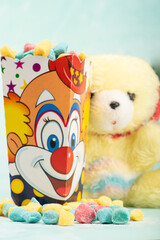 Sweets, beautiful colorful candies and accessories positioned on light surface, selective focus.