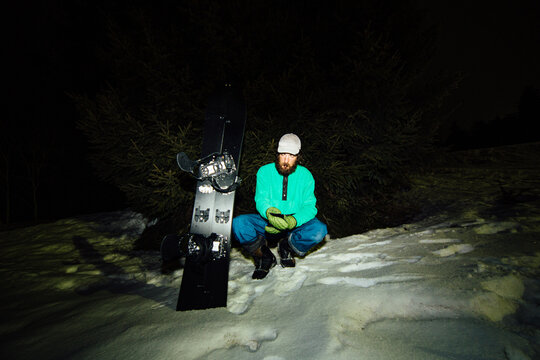 A skier rests on the snow