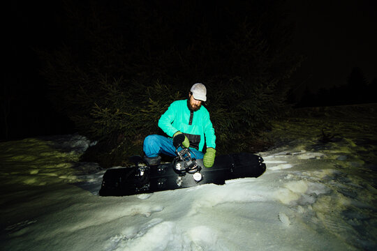 A man adjusts bindings on skis