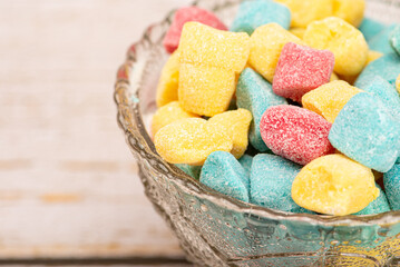 Sweets, beautiful colorful candies arranged on rustic wooden surface, selective focus.