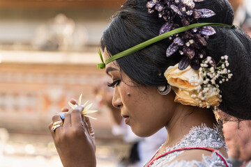 Balinese bride and caucasian groom during multiracial wedding ceremony